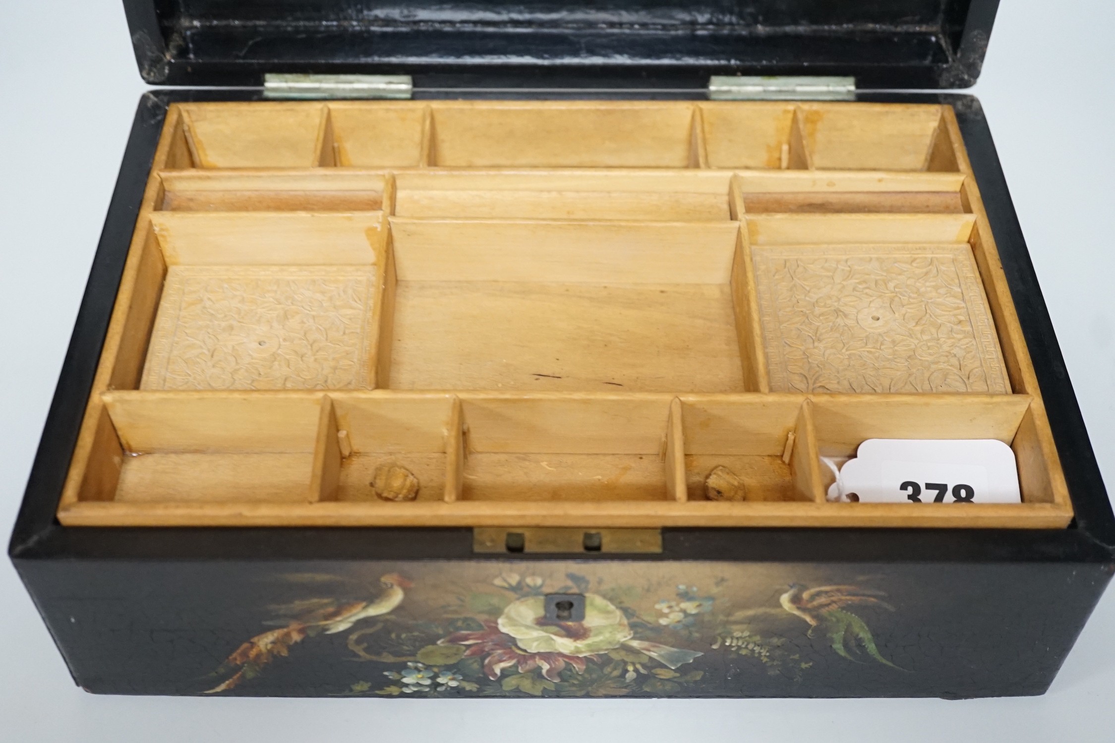 A Victorian painted papier-mâché sewing box, with peacock, blossom and gilt decoration with wooden inset, 30cms wide x 11cms high